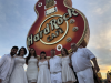 Posing with the Hard Rock Cafe Sign in Las Vegas at the Neon Museum